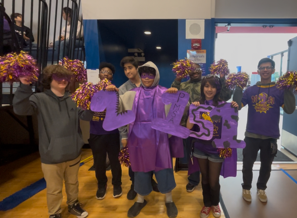 Team 2151 students celebrating together in purple team gear
